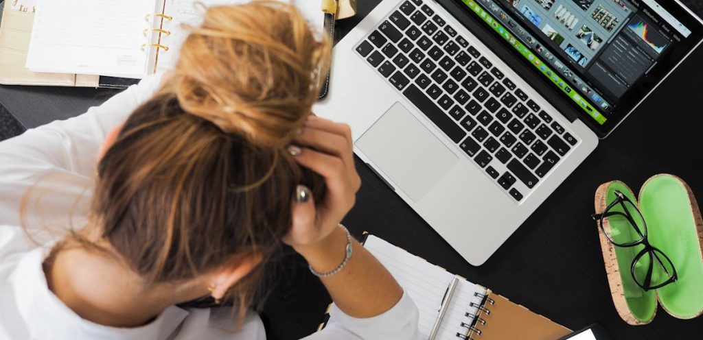 Woman Sitting in Front of Macbook